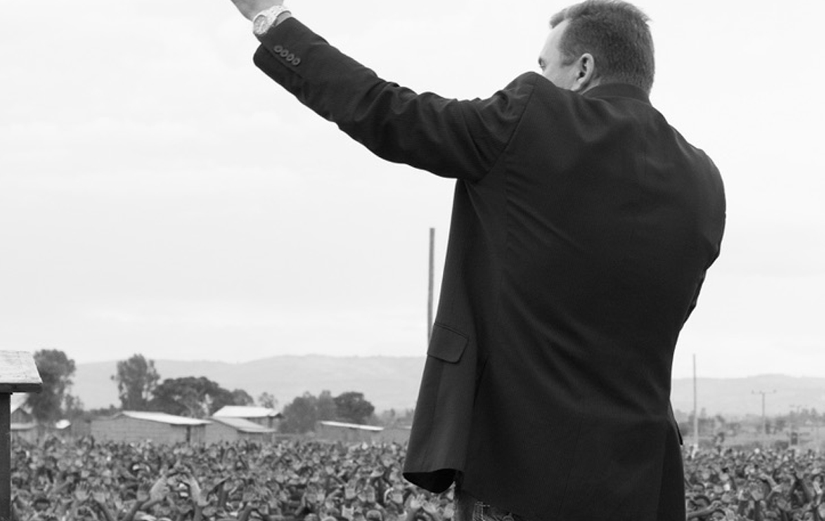 Preacher preaching to a large crowd.